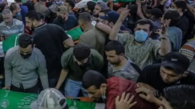 Palestinians attend the funeral of 15 people killed in an Israeli air strike in Gaza City. Photo: 13 May 2021