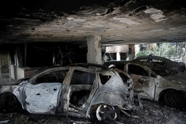 Burnt cars in Israel's city of Petah Tikva after a rocket strike from Gaza