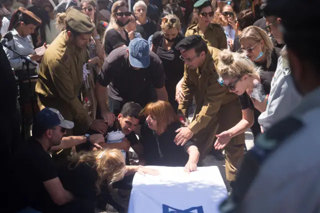 Relatives and friends touch the coffin of First Sergeant Omer Tabib in Israel