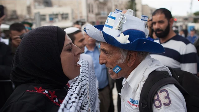 A pro-Palestinian woman and a pro-Israeli man shouting at each other