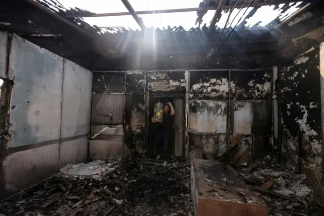 Torah scrolls, Jewish holy scriptures, are removed from a torched synagogue in Lod, Israel.Photo: 12 May 2021