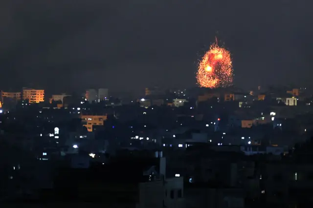 An explosion lights the sky following an Israeli air strike on Beit Lahia in the northern Gaza Strip