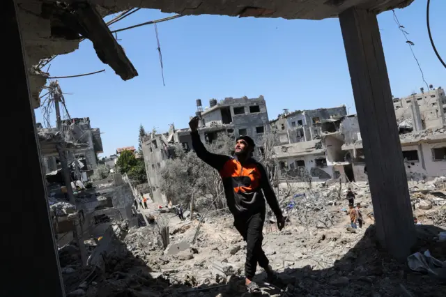 A Palestinian man in the northern Gaza Strip shows destroyed houses in the aftermath of Israeli air and artillery strikes.