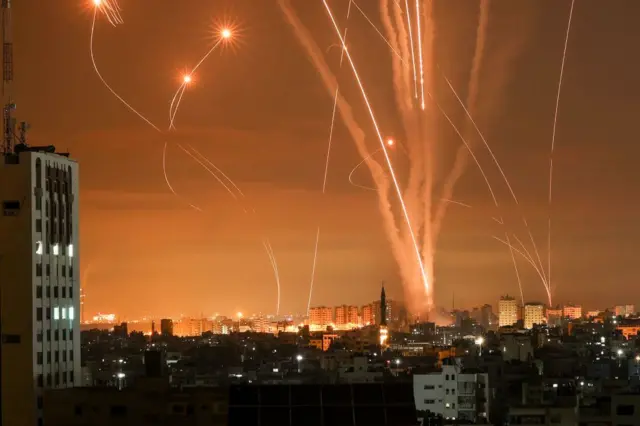 Rockets light up the night sky as they are fired towards Israel from Beit Lahia in the northern Gaza Strip