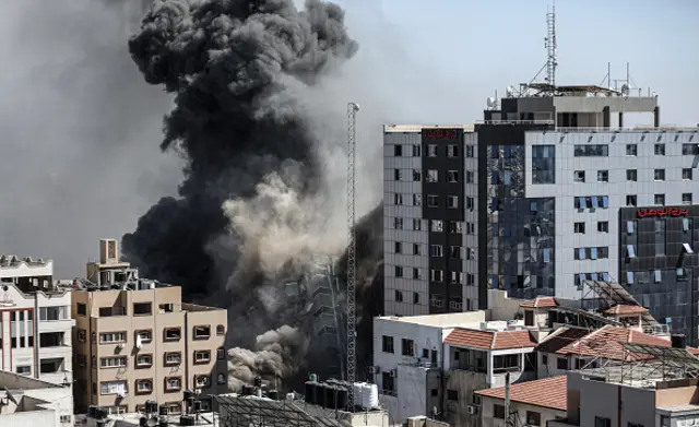 Smoke rises after Israeli forces destroyed a building in Gaza City where Al-Jazeera, Associated Press had their offices, on May 15, 2021