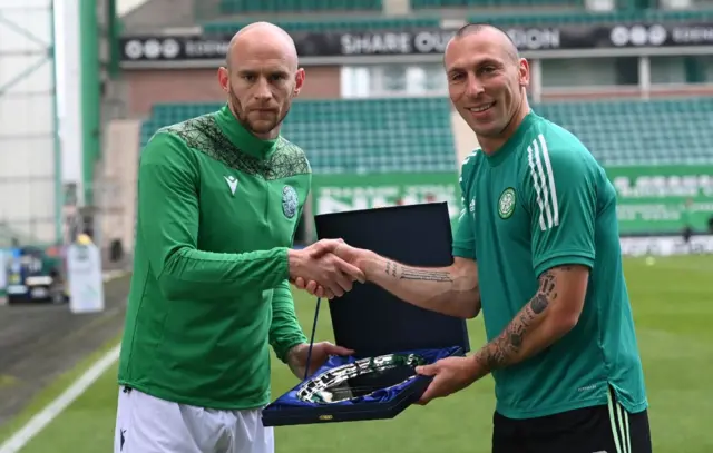 Hibs captain David Gray presents Scott Brown with a gift on his last Celtic appearance