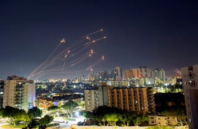 Streaks of light are seen from Ashkelon as Israel's Iron Dome anti-missile system intercepts rockets launched from the Gaza Strip towards Israel, on 15 May 2021