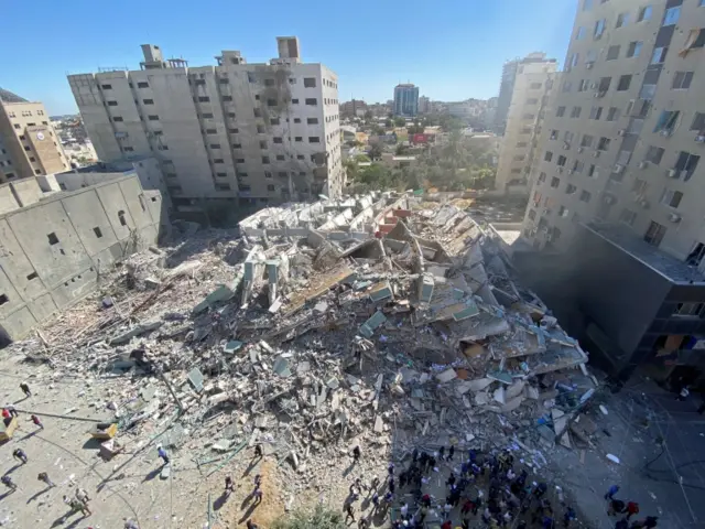 A tower housing AP, Al Jazeera offices collapses after Israeli missile strikes in Gaza city, on 15 May 2021