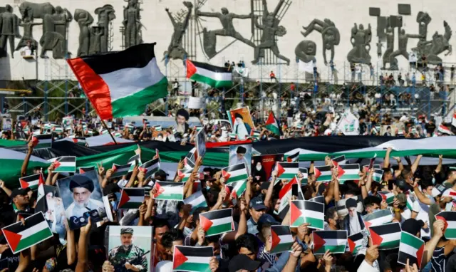 Iraqi demonstrators wave Palestinian flags during a protest to express solidarity with the Palestinian people amid a flare-up of Israeli-Palestinian violence, in Baghdad, Iraq, on 15 May 2021