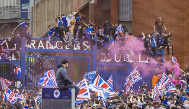 Rangers fans celebrate outside Ibrox