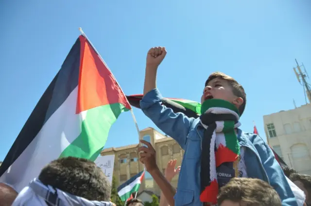 A child shouts during a protest to express solidarity with the Palestinian people, near the Israeli embassy in Amman, Jordan, on 15 May 2021