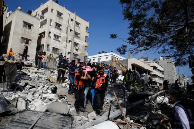 Victims carried from bombed building in Gaza