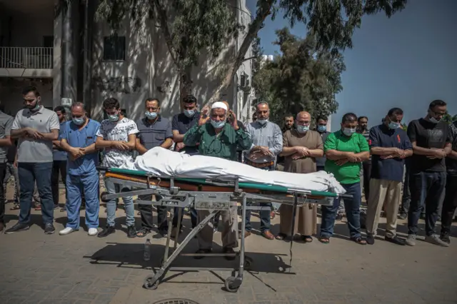 Palestinians perform funeral prayers for a member of the al-Kulak family, who was killed during an Israeli raid on Gaza City on May 16, 2021 in Gaza City