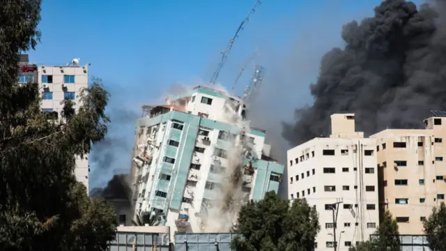 An Israeli airstrike destroys a high-rise building in Gaza City, Gaza Strip, that housed media outlets including The Associated Press and Al Jazeera