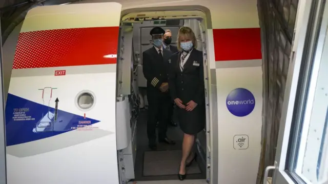 A British Airways cabin crew prepare for the return of customers