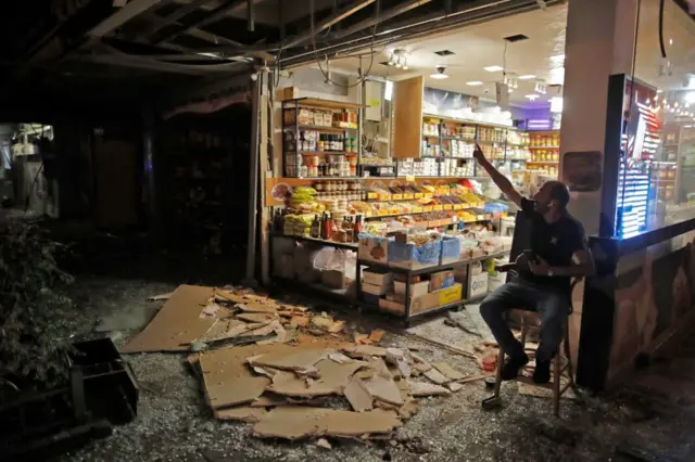 Image shows a damaged shop in Gaza