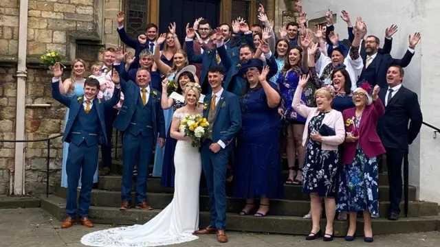 A group photo of the wedding party