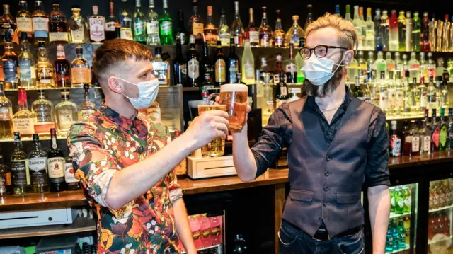 Bar staff celebrate in a pub