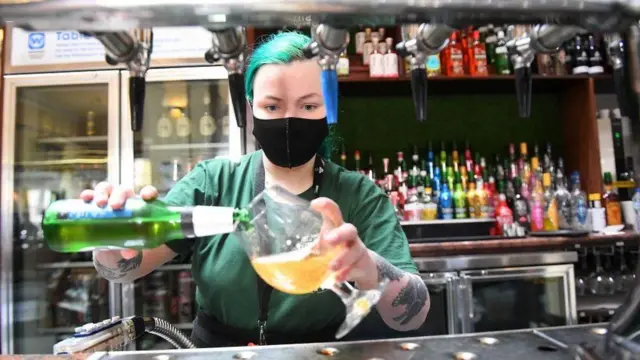 A woman pouring a drink