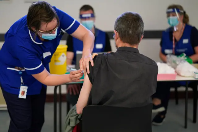 Man receives vaccine at Penrith Auction mart site