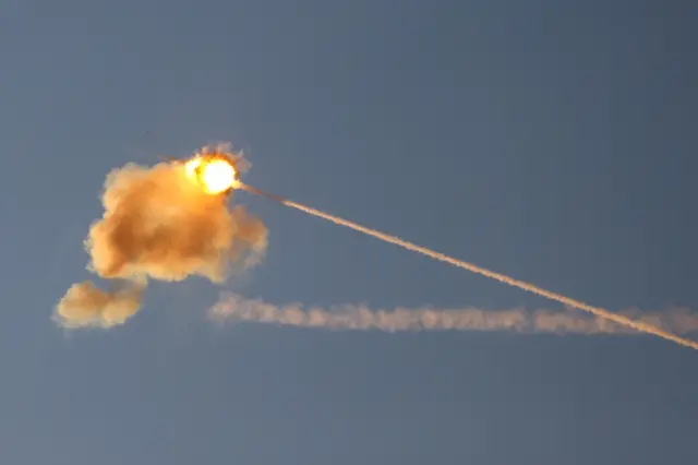 An explosion is seen midair as Israel's Iron Dome anti-missile system intercepts a rocket launched from the Gaza Strip