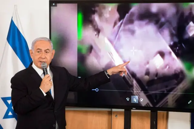 Israeli Prime Minister Benjamin Netanyahu shows a slideshow during a briefing to foreign ambassadors in Tel Aviv, Israel. Photo: 19 May 2021