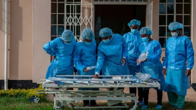 People in personal protective equipment are seen at a lodging building readying for their turn to go and work inside the main COVID-19 treatment centre at Kamuzu Central Hospital in Lilongwe, Malawi