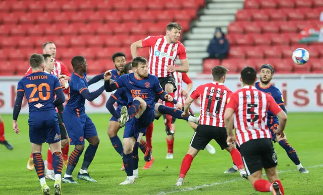 Charlie Wyke gets up for a header