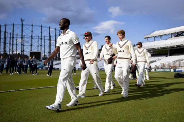 Kemar Roach leads Surrey off after their innings win over Hampshire