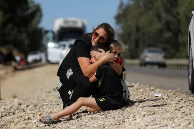 woman protects children in Sderot