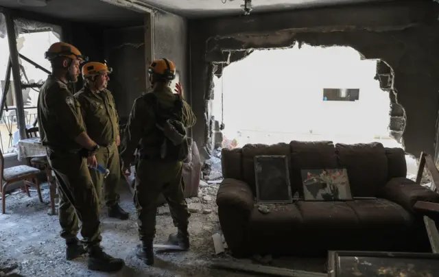 Israeli army officers visit the site where rockets launched from Gaza fell in the Israeli city of Petah Tikva, Israeli, during the visit of the German Minister of Foreign Affairs, Heiko Maas to the site 20 May 2021.