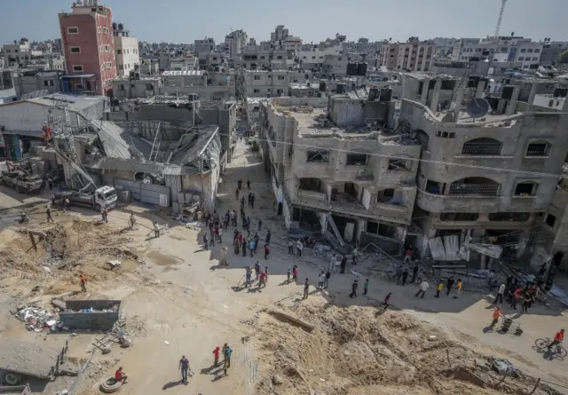 Palestinians inspect their destroyed house after Israeli air strikes in Jabaliya refugee camp northern Gaza Strip