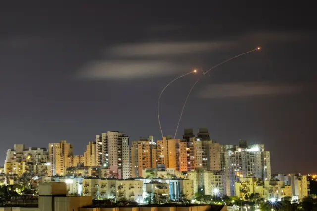 Streaks of light are seen as Israel's Iron Dome anti-missile system intercepts rockets