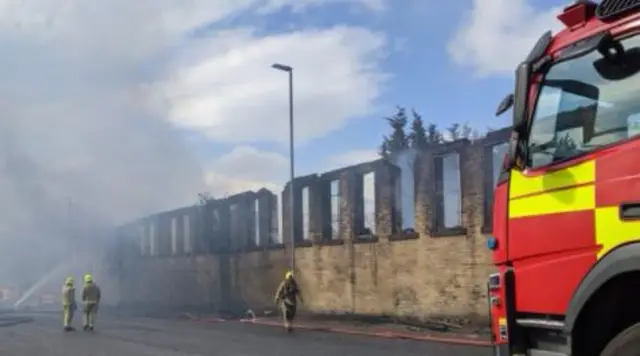 Smoke and firefighters at Bradford warehouse blaze