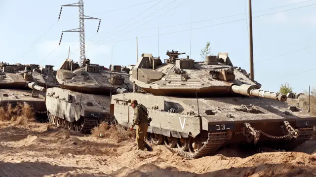 Israeli Merkava tanks are deployed along the border with the Gaza Strip on May 20, 2021.