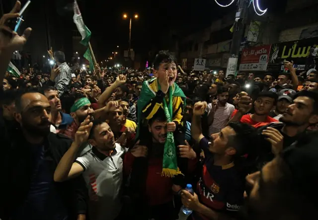 Palestinians gather for a celebration after "mutual and simultaneous" cease-fire deal, ending the 11-day conflict, in Rafah, Gaza on May 21, 2021