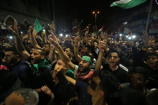 Palestinians gather for a celebration after "mutual and simultaneous" ceasefire deal, ending the 11-day conflict, in Rafah, Gaza on May 21, 2021