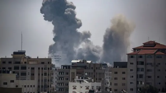 Smoke rises from Gaza City following an Israeli air strike on 16 May 2021