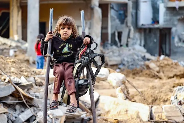 A young Palestinian girl sits amidst rubble in her neighbourhood hit by Israeli bombardment in Gaza City, after a ceasefire brokered by Egypt between Israel and Hamas, on May 21, 2021