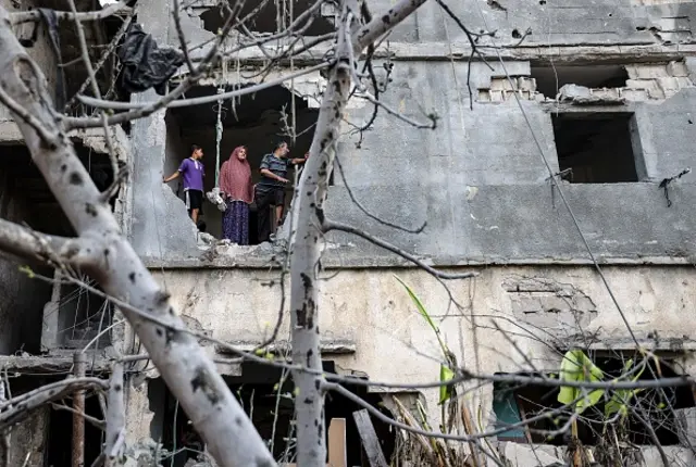 Palestinians return to her neighbourhood hit by Israeli bombardment in Gaza City, after a ceasefire brokered by Egypt between Israel and Hamas, on May 21, 2021