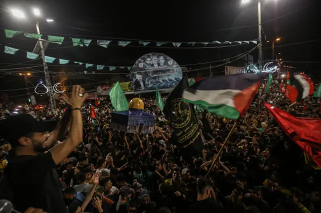 Palestinians carry a model of Dome of the Rock (Kubbet'us-Sahra) as they gather for a celebration after "mutual and simultaneous" cease-fire deal between Israel and Hamas reached with Egypt mediation took effect at 2 a.m. Friday (2300GMT Thursday), ending the 11-day conflict, in Rafah, Gaza on May 21, 2021.