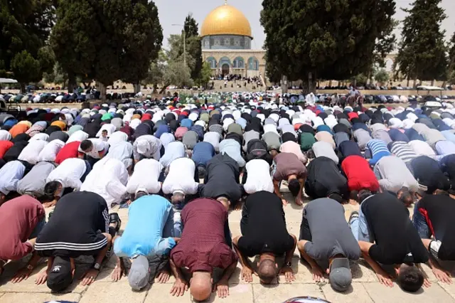 Palestinian Muslim devotees perform the first Friday prayers after a ceasefire brokered by Egypt between Israel and Hamas, in Jerusalem's al-Aqsa mosque compound, the third holiest site of Islam, on May 21, 2021