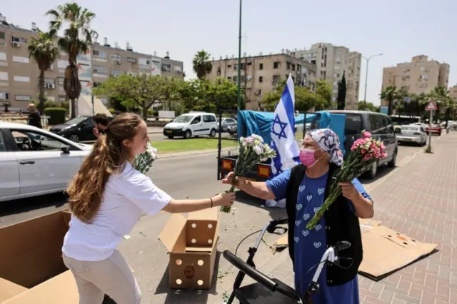 Women exchange flowers in Ashkelon, Israel