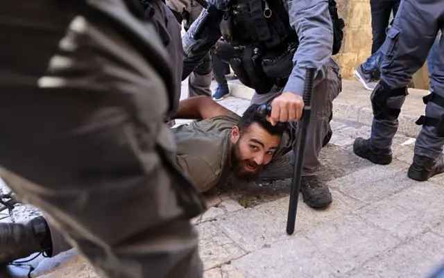 Israeli border police detain a Palestinian man during protests against Israel's occupation and its air campaign on the Gaza strip, at Damascus Gate in East Jerusalem, on May 18, 2021