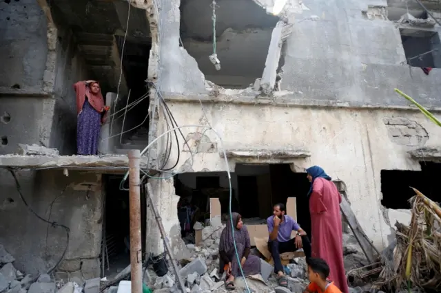 Gazans in ruined building