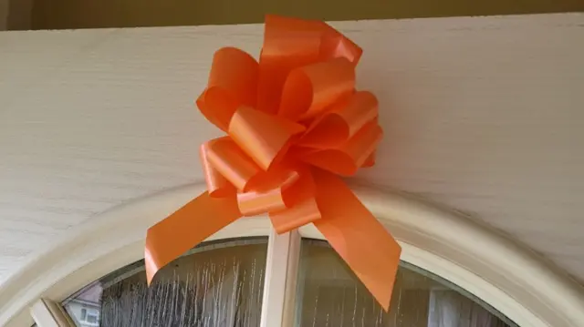 Orange ribbon on door