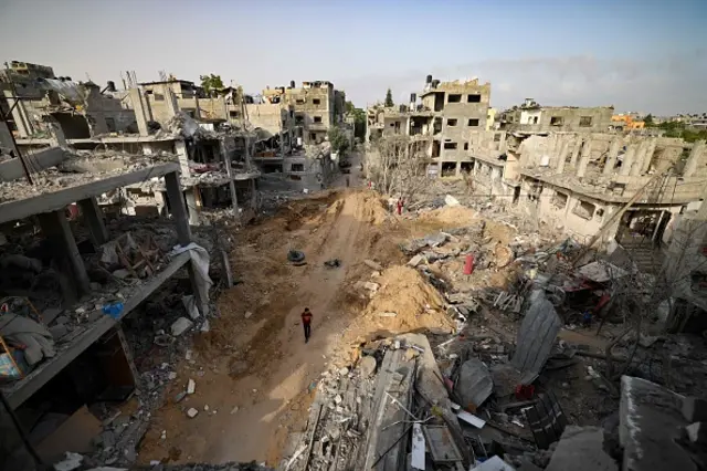 Palestinians return to her neighbourhood hit by Israeli bombardment in Gaza City, after a ceasefire brokered by Egypt between Israel and Hamas, on May 21, 2021