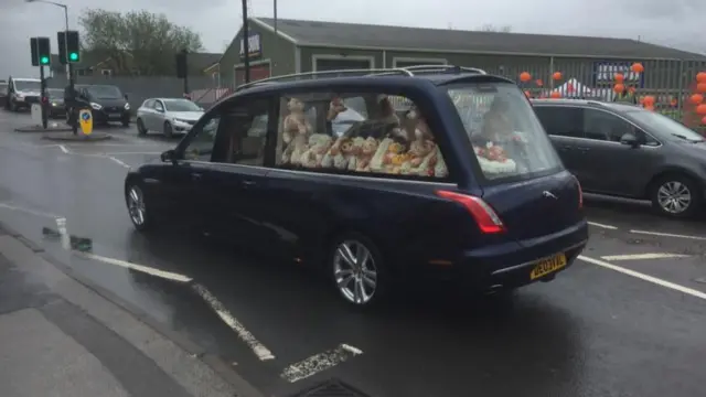 Floral tributes in one of the cars in the procession