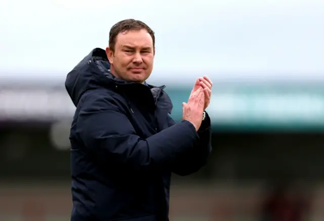 Derek Adams applauds the Morecambe fans