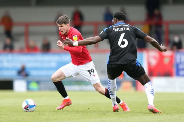 Liam McAlinden of Morecambe and Emmanuel Monthe of Tranmere